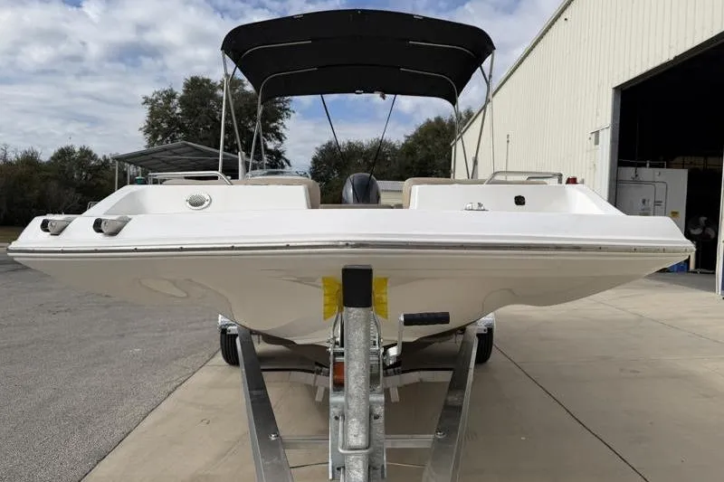 Slide: The Image of 2023 Hurricane SunDeck Sport 201 OB boat on trailer, outdoor setting. - 35