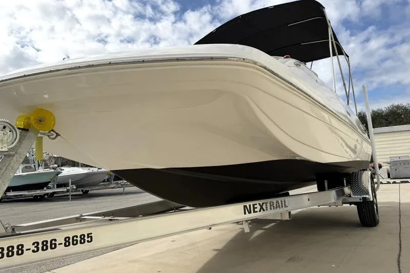 Slide: The Image of 2023 Hurricane SunDeck Sport 201 OB boat on trailer under cloudy sky. - 37