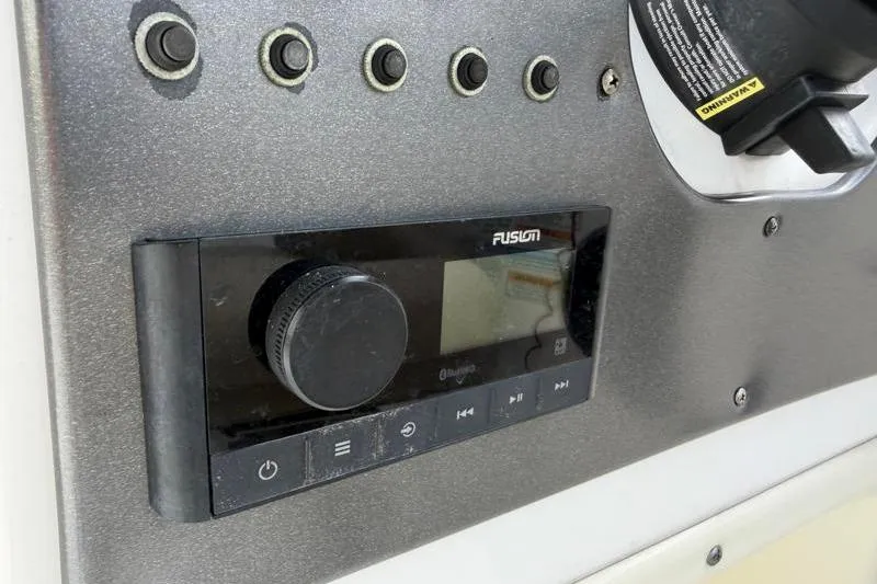 Slide: The Image of Control panel of 2023 Hurricane SunDeck Sport 201 OB boat with Fusion audio system. - 52