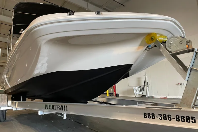 Slide: The Image of 2023 Hurricane SunDeck Sport 201 OB boat on trailer, viewed from front angle. - 8