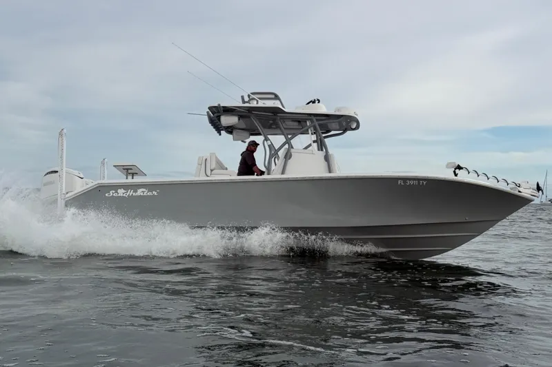 Slide: The Image of 2024 SeaHunter 28 Floridian boat cruising on water, side view. - 10