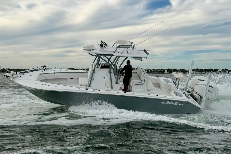 Slide: The Image of 2024 SeaHunter 28 Floridian boat cruising on water under a cloudy sky. - 11