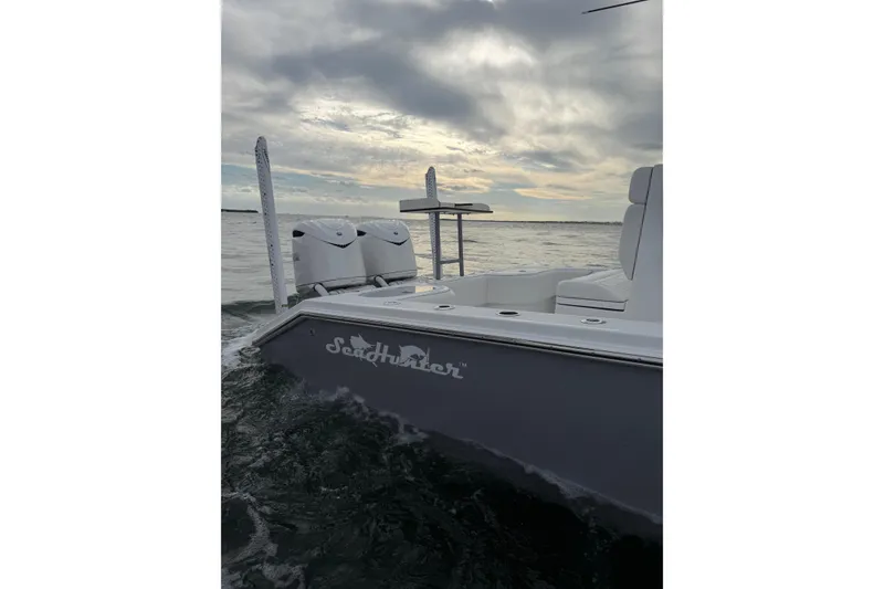 Slide: The Image of 2024 SeaHunter 28 Floridian boat on water under cloudy sky. - 13