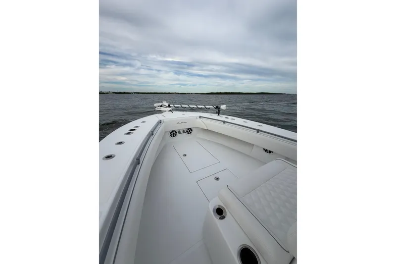 Slide: The Image of 2024 SeaHunter 28 Floridian boat on open water under cloudy sky. - 14