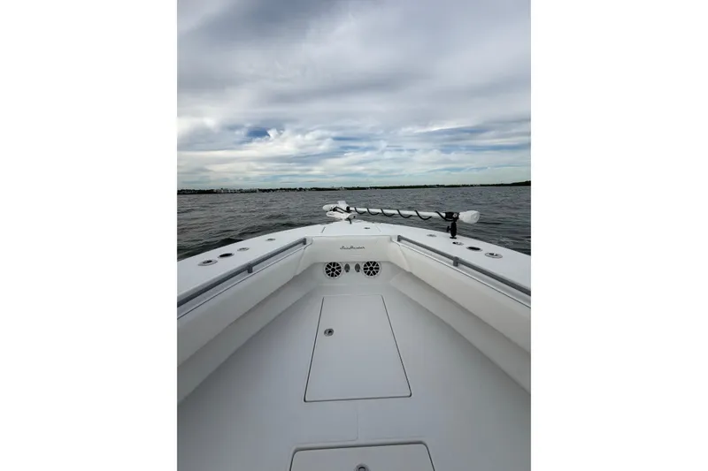 Slide: The Image of 2024 SeaHunter 28 Floridian boat on open water under cloudy sky. - 15
