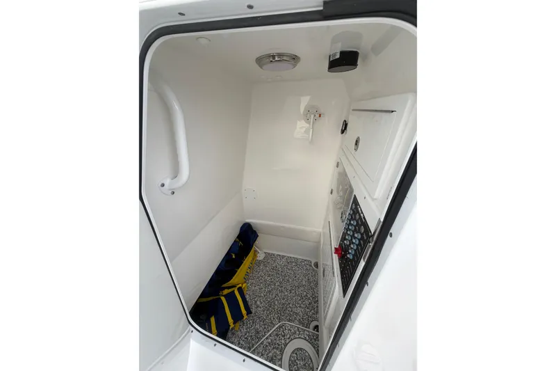 Slide: The Image of 2024 SeaHunter 28 Floridian interior cabin with control panel and storage space. - 18