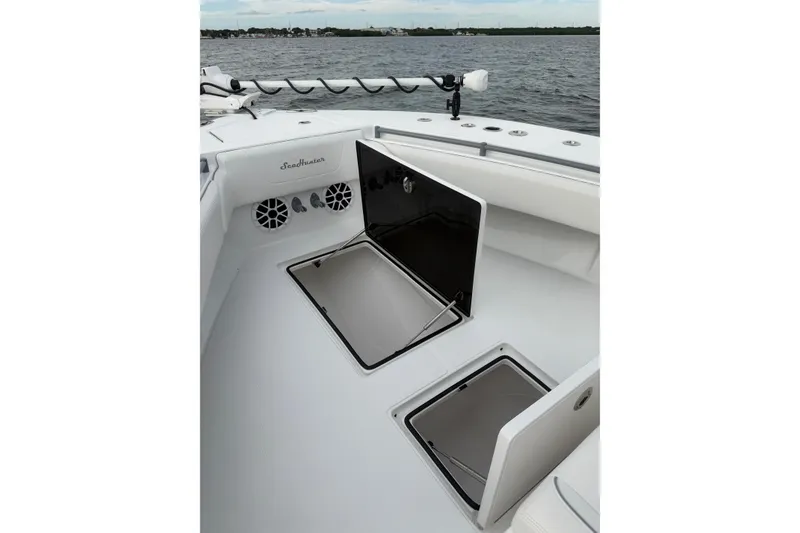 Slide: The Image of 2024 SeaHunter 28 Floridian boat deck with open storage compartments. - 19