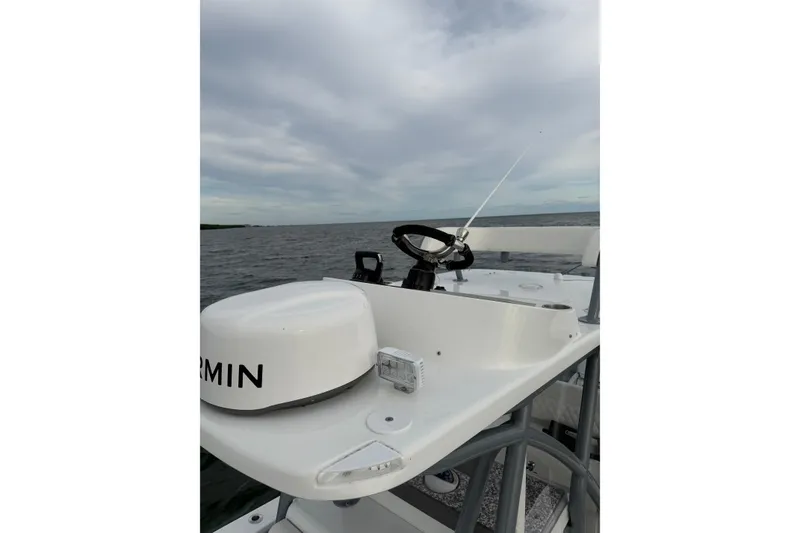 Slide: The Image of 2024 SeaHunter 28 Floridian boat helm with Garmin equipment on open water. - 21