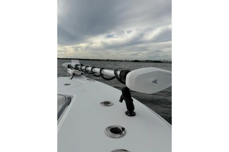 Slide: The Image of 2024 SeaHunter 28 Floridian boat on water, featuring sleek deck design and overcast sky. - 22