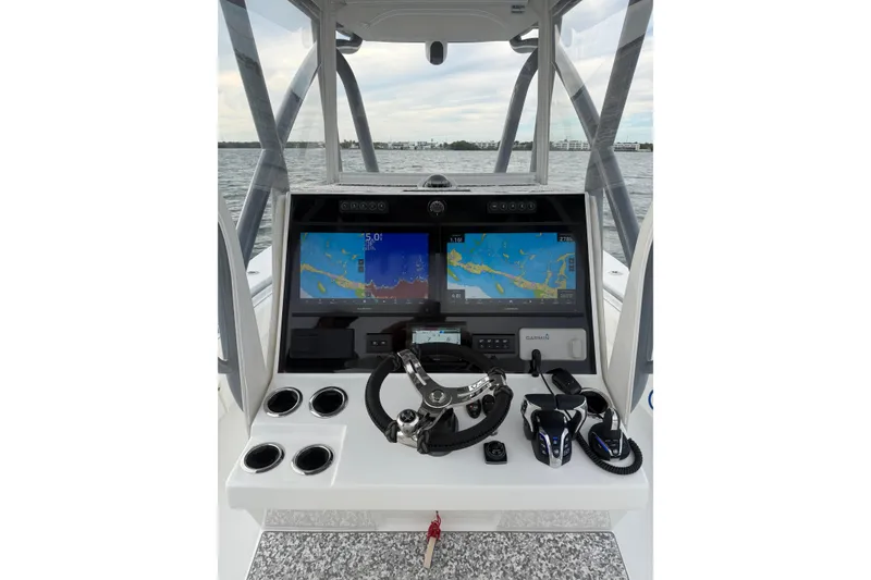 Slide: The Image of 2024 SeaHunter 28 Floridian boat dashboard with navigation screens and controls. - 24
