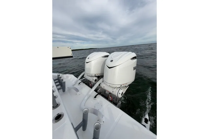 Slide: The Image of 2024 SeaHunter 28 Floridian boat with dual outboard engines on open water. - 26