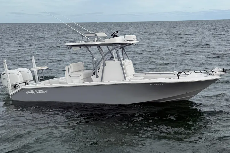 Slide: The Image of 2024 SeaHunter 28 Floridian boat on open water, featuring dual engines and fishing equipment. - 3