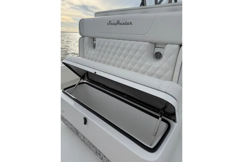 Slide: The Image of 2024 SeaHunter 28 Floridian boat with open storage compartment, white quilted seating. - 30