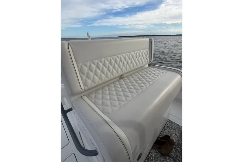 Slide: The Image of 2024 SeaHunter 28 Floridian boat with luxurious quilted seating on open water. - 32