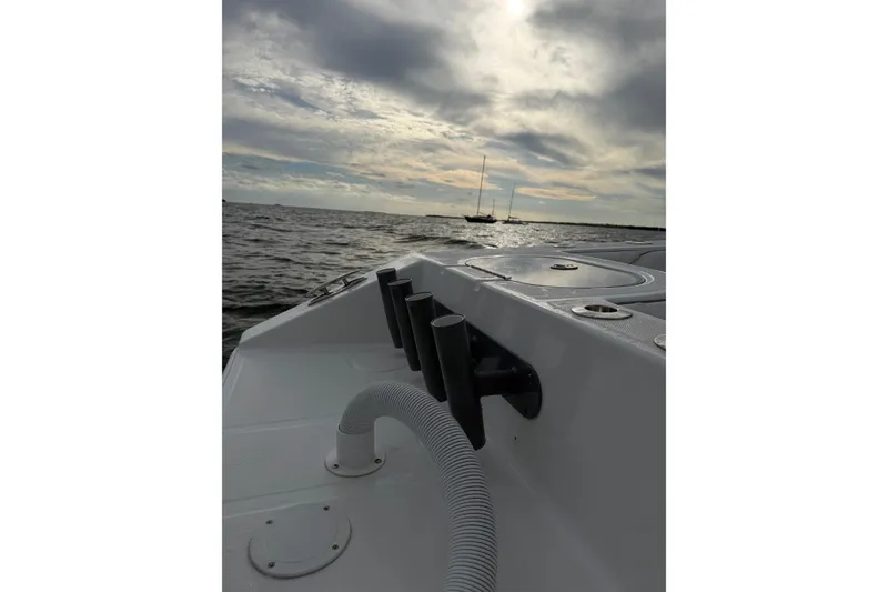 Slide: The Image of 2024 SeaHunter 28 Floridian boat on water, cloudy sky, and distant sailboats. - 39