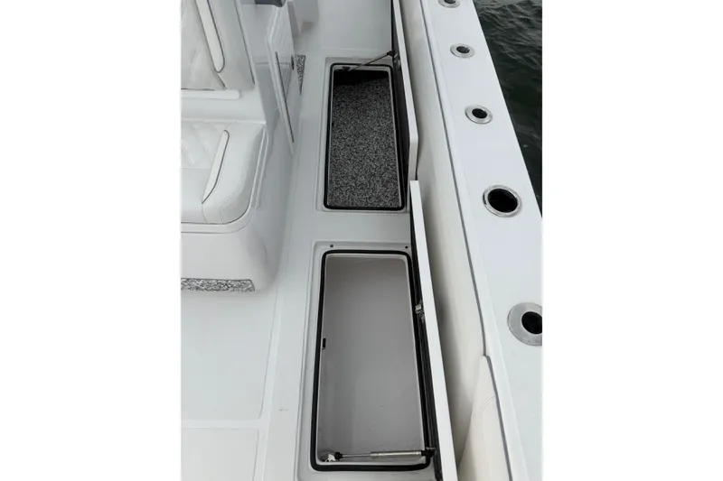 Slide: The Image of 2024 SeaHunter 28 Floridian boat deck with open storage compartments. - 41