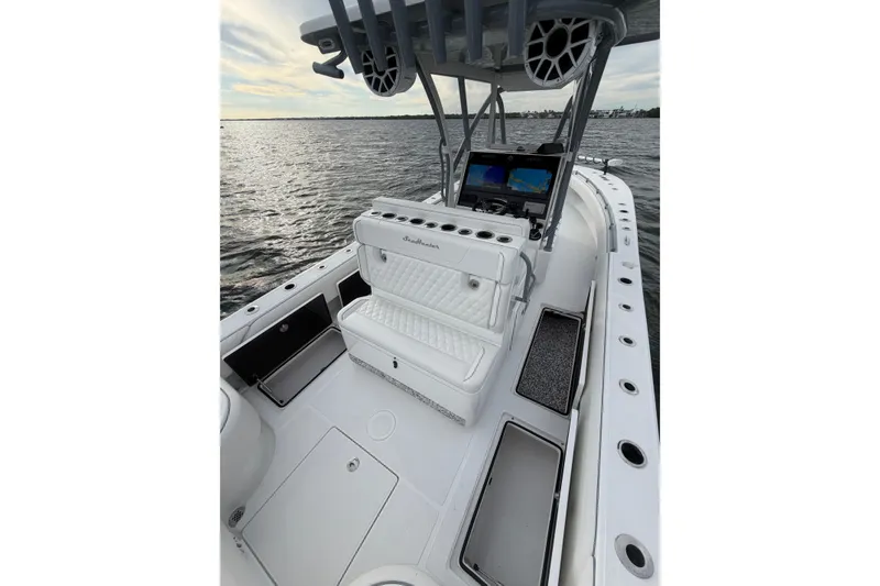 Slide: The Image of 2024 SeaHunter 28 Floridian boat interior with seating and navigation equipment on the water. - 42