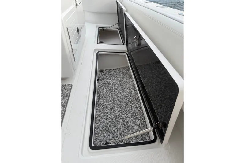 Slide: The Image of 2024 SeaHunter 28 Floridian boat storage compartments with open lids, showcasing interior space. - 43