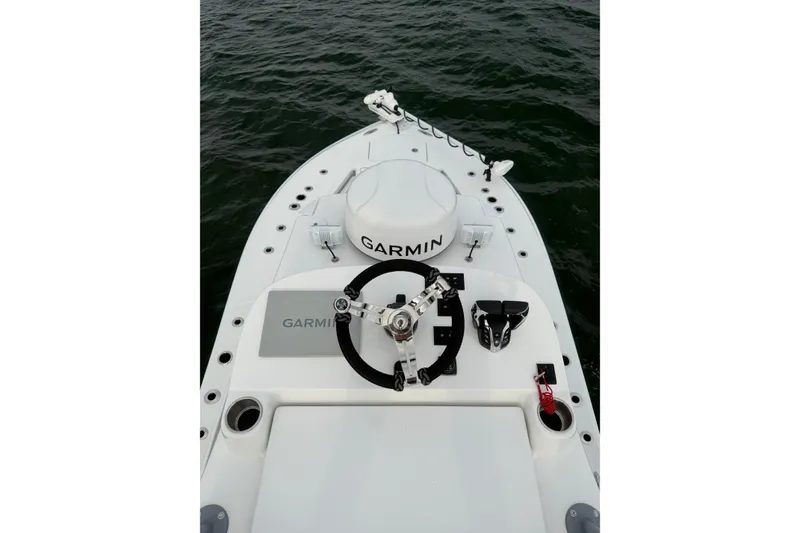 Slide: The Image of 2024 SeaHunter 28 Floridian boat helm with Garmin equipment on open water. - 48