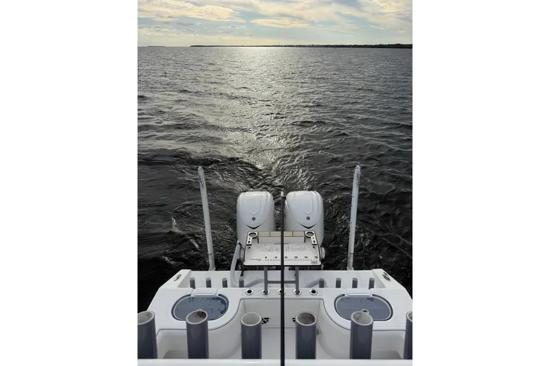 Slide: The Image of 2024 SeaHunter 28 Floridian boat on open water, showcasing dual engines and fishing rod holders. - 49
