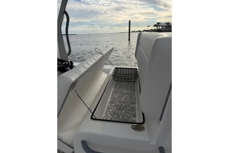 Slide: The Image of 2024 SeaHunter 28 Floridian boat interior with open storage compartment, ocean view. - 51