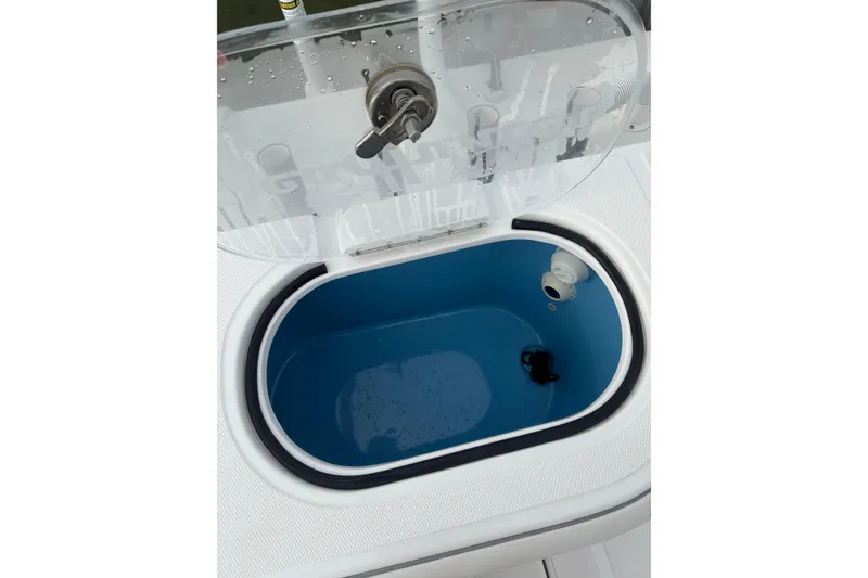 Slide: The Image of 2024 SeaHunter 28 Floridian livewell with open lid, showcasing interior design. - 53