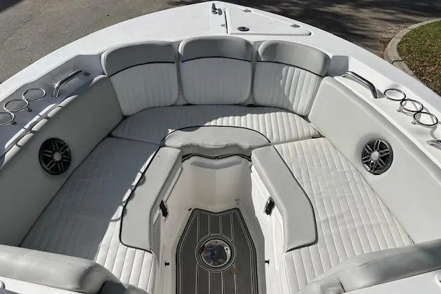 Slide: The Image of 2021 Sea Fox 226 Traveler boat interior with white cushioned seating and cup holders. - 10