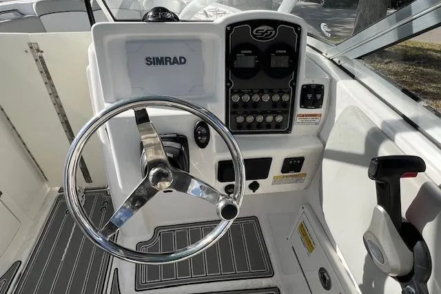 Slide: The Image of 2021 Sea Fox 226 Traveler boat dashboard with Simrad display and steering wheel. - 7