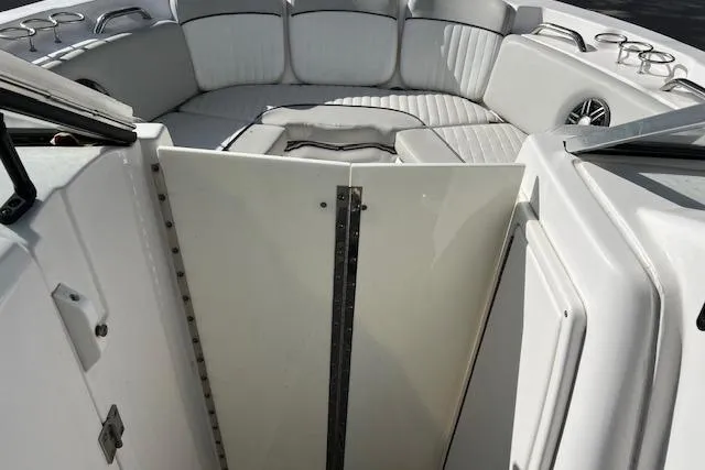 Slide: The Image of 2021 Sea Fox 226 Traveler boat interior with white cushioned seating and cup holders. - 8