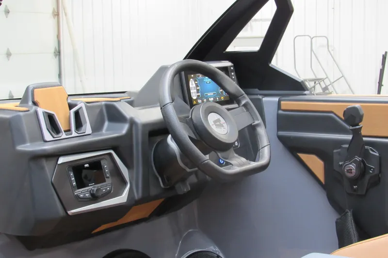 Slide: The Image of 2026 Axis A225 boat dashboard with steering wheel and control panel. - 14