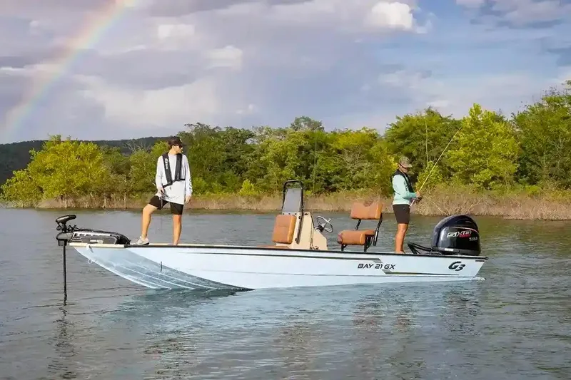 Slide: The Image of Manufacturer Provided Image: 2026 G3 Bay 21 GX boat on water, two people fishing, rainbow in background. - 2