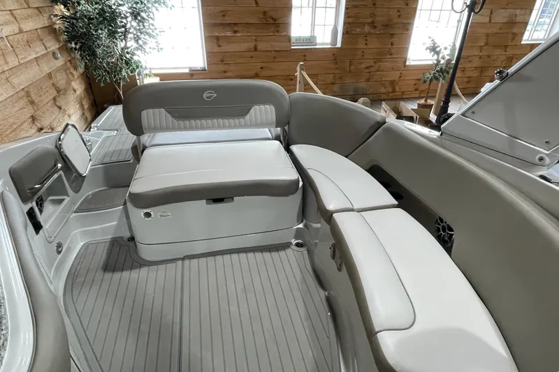 Slide: The Image of 2026 Crownline 298 SS boat interior with elegant seating and wood-paneled walls. - 15