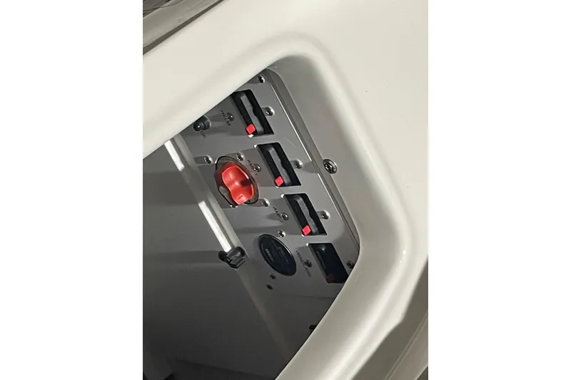 Slide: The Image of Control panel of 2026 Crownline 298 SS boat with switches and red knob. - 17