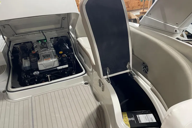 Slide: The Image of 2026 Crownline 298 SS boat engine compartment with V8 engine and storage area. - 19