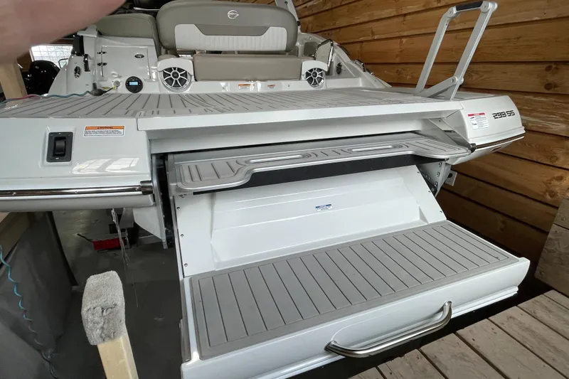 Slide: The Image of 2026 Crownline 298 SS boat with extended swim platform and seating area. - 3