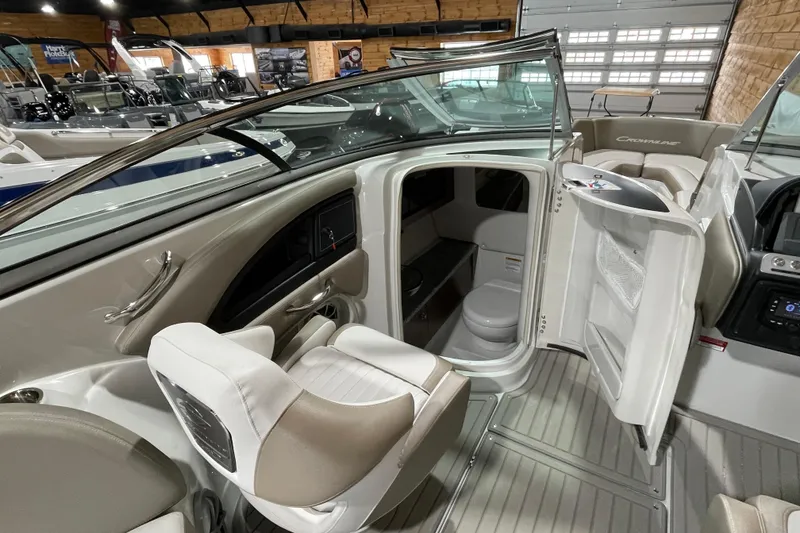 Slide: The Image of 2026 Crownline 298 SS boat interior with seating and cabin view. - 8