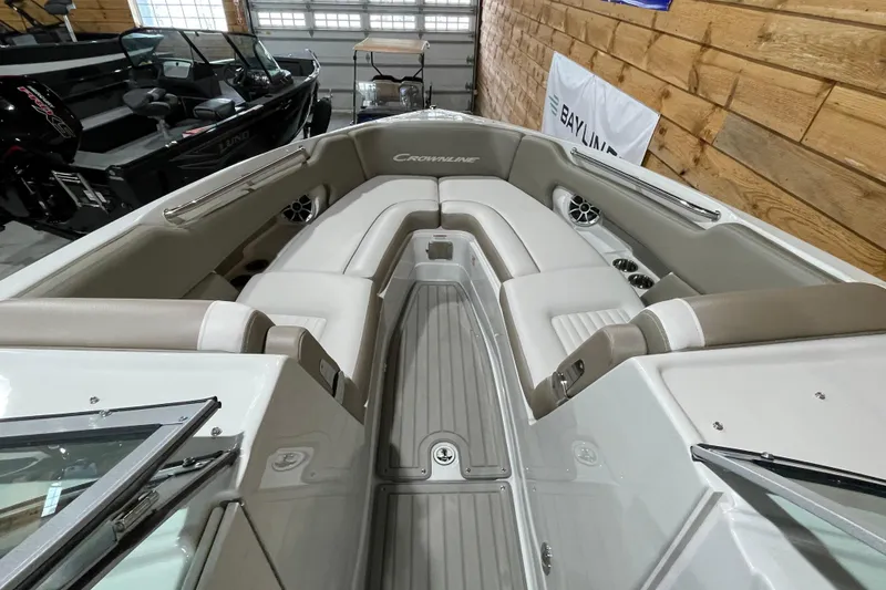 Slide: The Image of 2026 Crownline 298 SS boat interior with beige seating and modern design. - 9