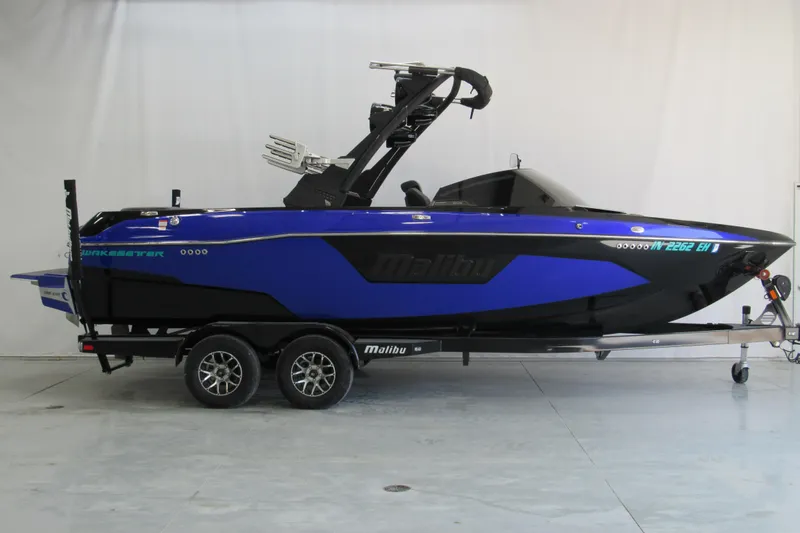 The Image of 2021 Malibu Wakesetter 23 LSV boat in blue and black on trailer. - 0