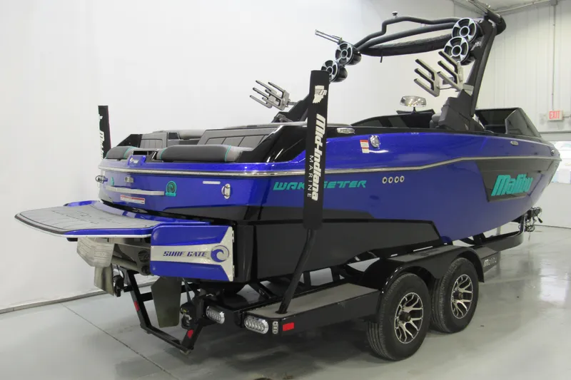Slide: The Image of 2021 Malibu Wakesetter 23 LSV boat in blue, on a trailer, in a showroom. - 3