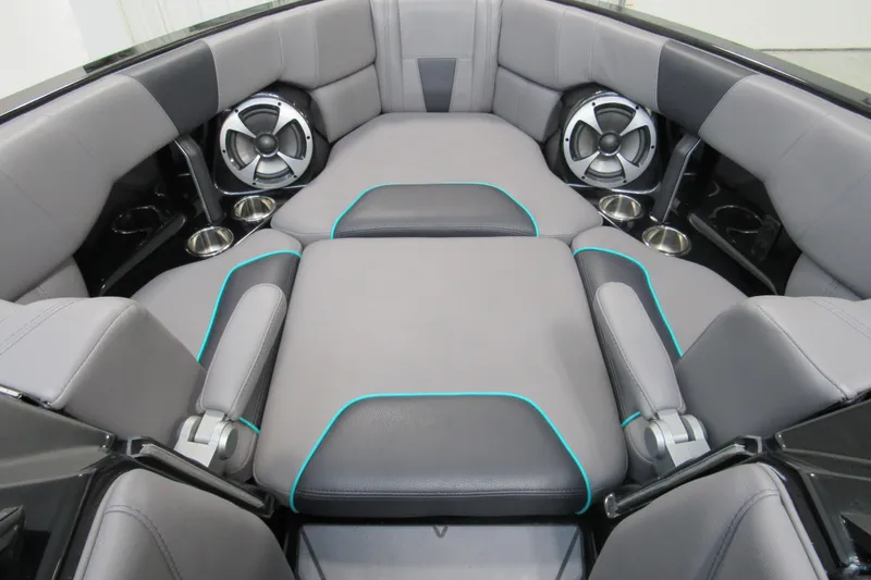 Slide: The Image of 2021 Malibu Wakesetter 23 LSV interior with gray seating, teal accents, and built-in speakers. - 8