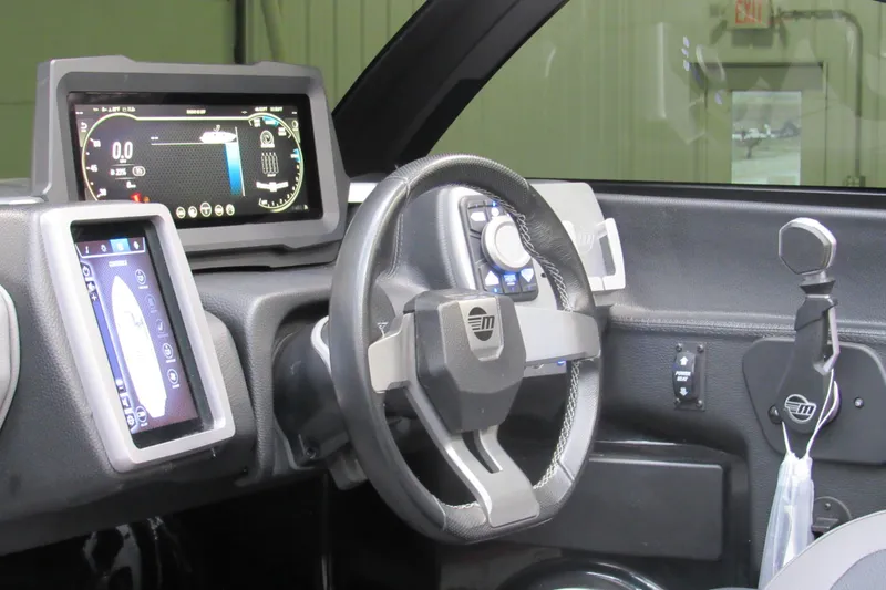 Slide: The Image of 2021 Malibu Wakesetter 23 LSV dashboard with advanced digital controls and steering wheel. - 9