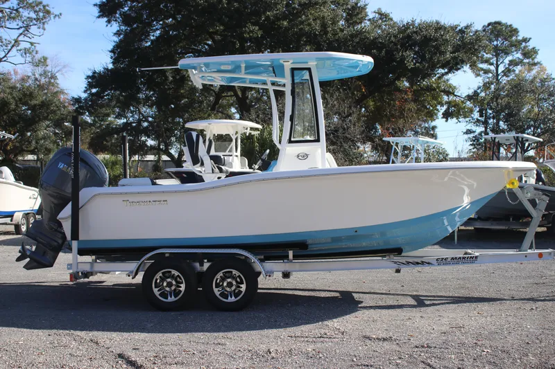 Slide: The Image of 2026 Tidewater 210 LXF boat on trailer, side view, outdoors. - 12
