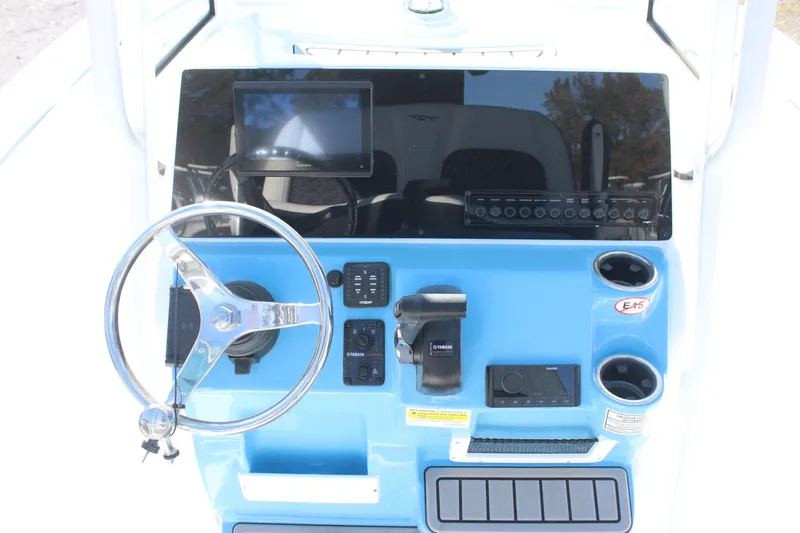 Slide: The Image of 2026 Tidewater 210 LXF boat dashboard with steering wheel and electronic controls. - 19
