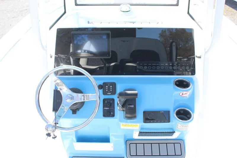 Slide: The Image of 2026 Tidewater 210 LXF boat dashboard with steering wheel and electronic controls. - 20