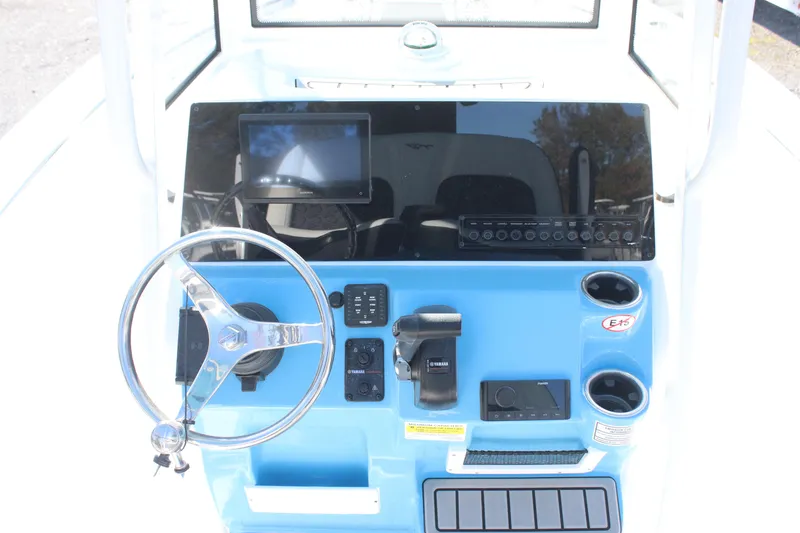 Slide: The Image of 2026 Tidewater 210 LXF boat dashboard with steering wheel and control panel. - 21