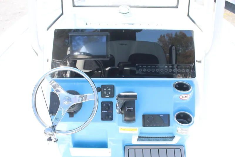 Slide: The Image of 2026 Tidewater 210 LXF boat dashboard with steering wheel and control panel. - 23
