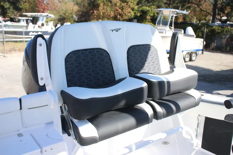 Slide: The Image of 2026 Tidewater 210 LXF boat seats with black and white upholstery, outdoor setting. - 24