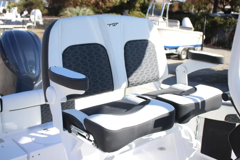Slide: The Image of 2026 Tidewater 210 LXF boat seats with black and white upholstery, featuring armrests. - 25