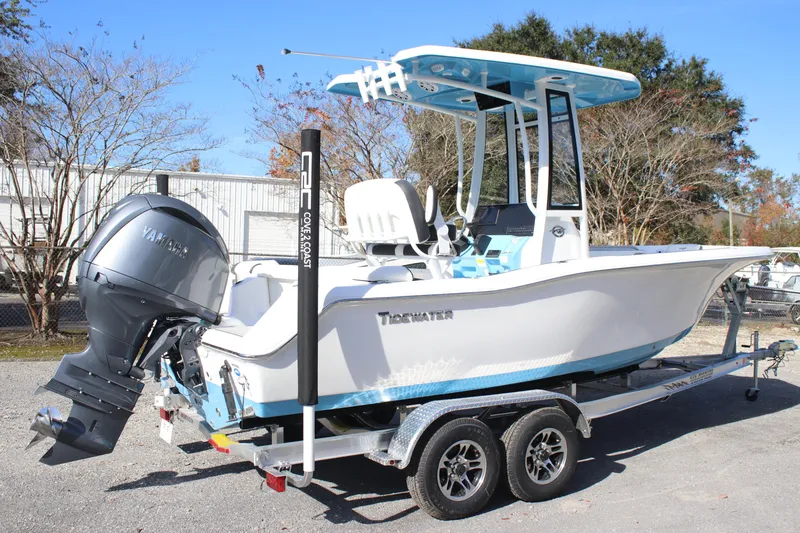 Slide: The Image of 2026 Tidewater 210 LXF boat on trailer with Yamaha outboard motor, parked outdoors. - 4