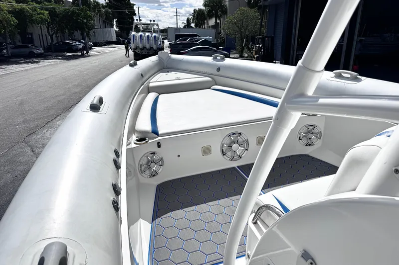 Slide: The Image of Airship 330 boat interior, 2014 model, featuring white seating and hexagonal floor design. - 11